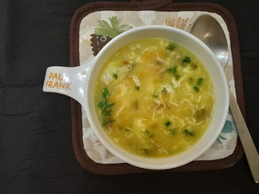 Garnish sweet corn spring onion soup with spring onion greens